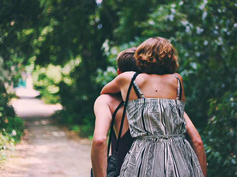 A couple riding a bike together on a first date and having a good time because they knew what not to do.