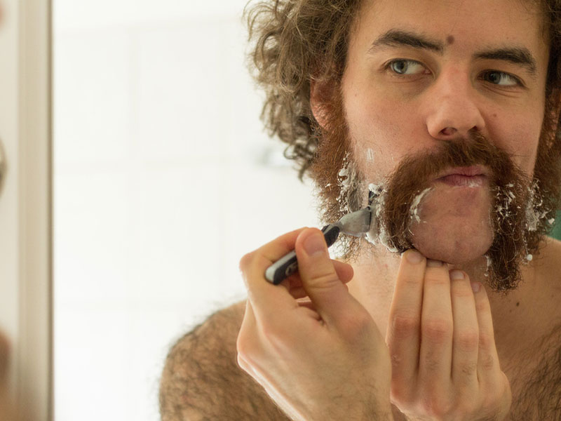 A guy shaving for movember.