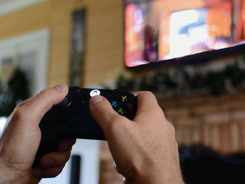 A man in a healthy relationship laying video games alone to get some time for himself.