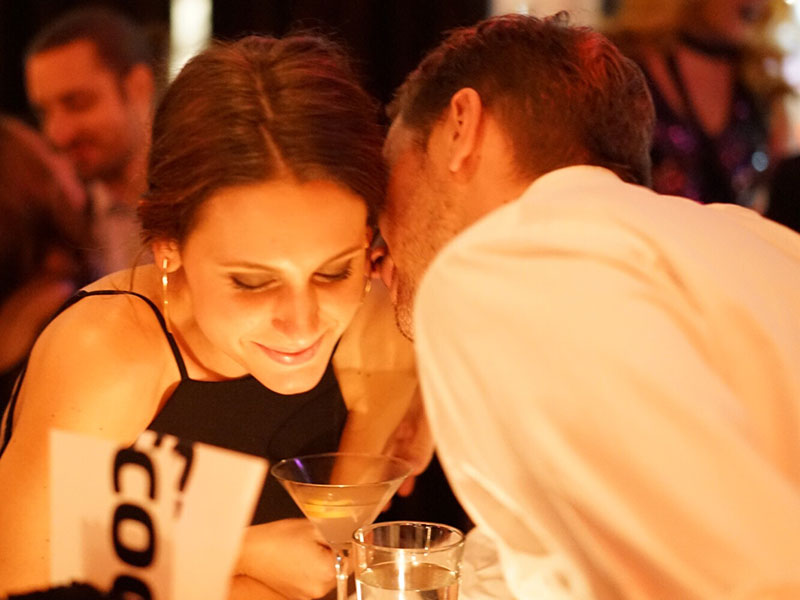 A man thinking of having an affair talking to a woman at a bar.