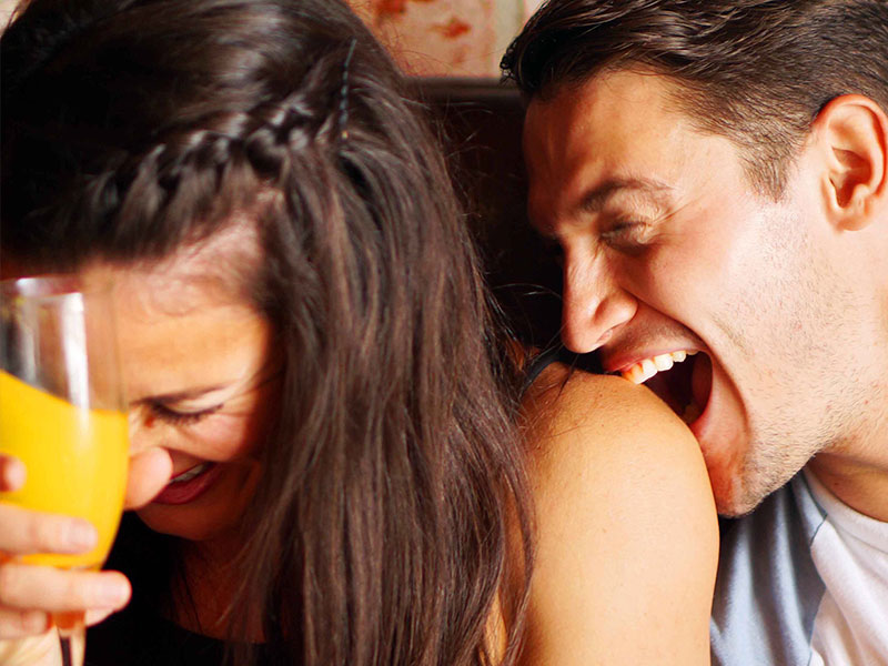 A guy sending a girl flirting signs while on a date.