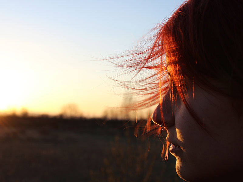 A girl who's moving on after a breakup thinking about things as she looks at the sunset.