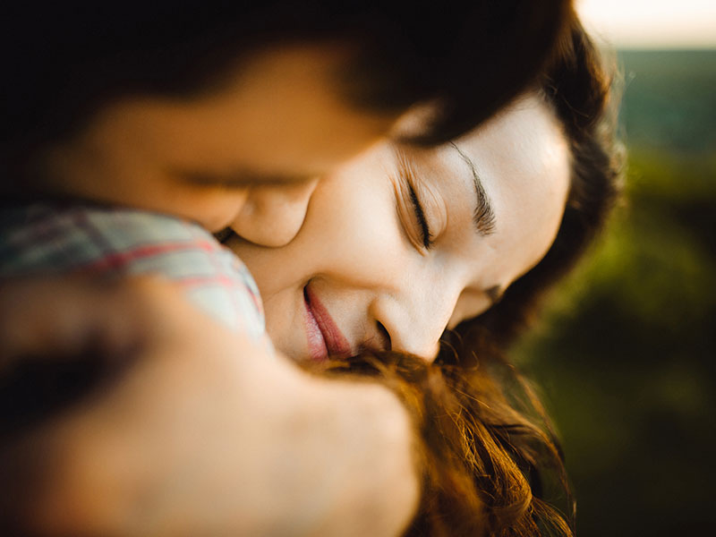 A woman who took some new relationship advice and now is hugging her boyfriend.