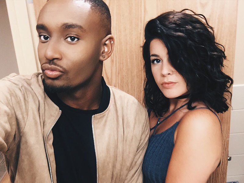 A guy with his girl friend taking a selfie in the mirror before being her wingman for the night.