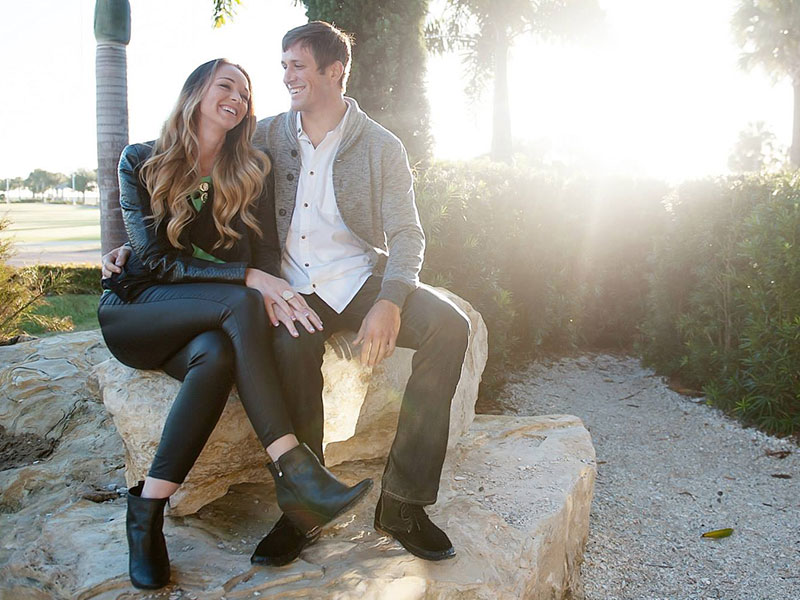 The stars of the I Do podcast laughing on a rock as they discuss online dating tips.