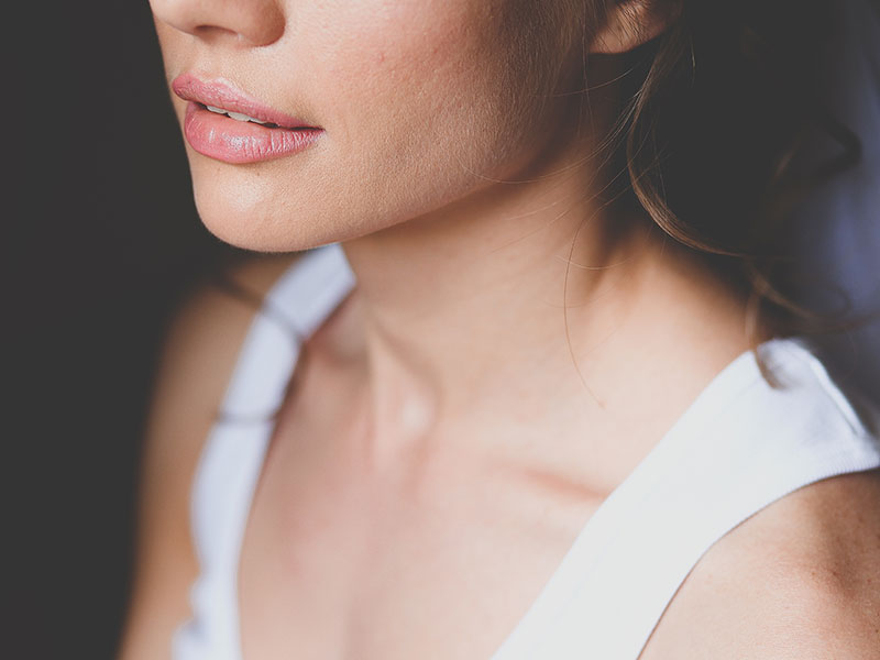 A woman in a wedding dress thinking about these signs you need to break off your engagement and contemplating her decision.