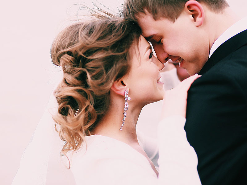 A woman who wants to know how to be a better wife, smiling at her husband on their wedding day.