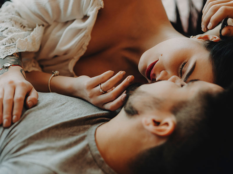 A couple lying together in bed even though they're with other people wondering what is considered cheating.