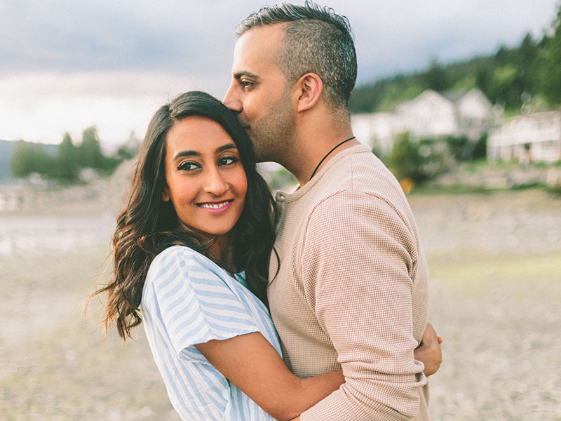 Happy couple smiling and embracing each other after a long distance relationship.