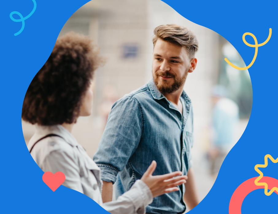 A woman looking at the man she’s interested in wondering, “Is he flirting with me?” while they walk down the street together.