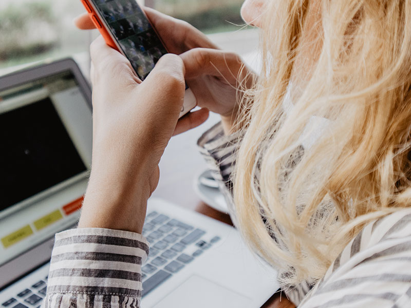 A woman using these dating profile tips to update her profile.