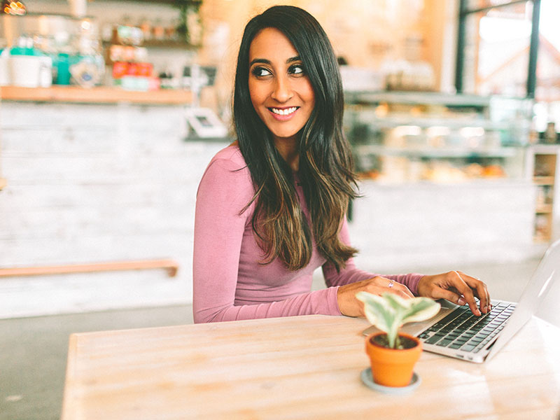 A girl meeting other singles at the coffee shop while working, one of these alternatives to dating apps.