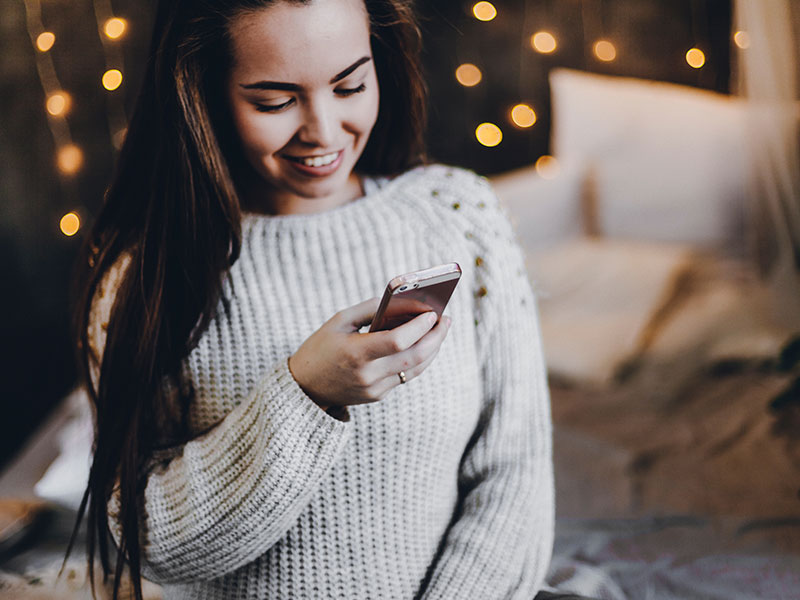 A woman texting her boyfriend and proving that absence makes the heart grow fonder.