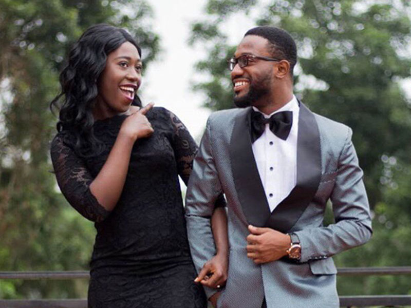 A woman and her boyfriend dressed up for an event and laughing even though the woman is future tripping a little bit.