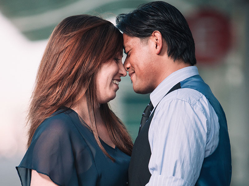 A man who's hugging his girlfriend and showing all the signs a man is falling in love with you.