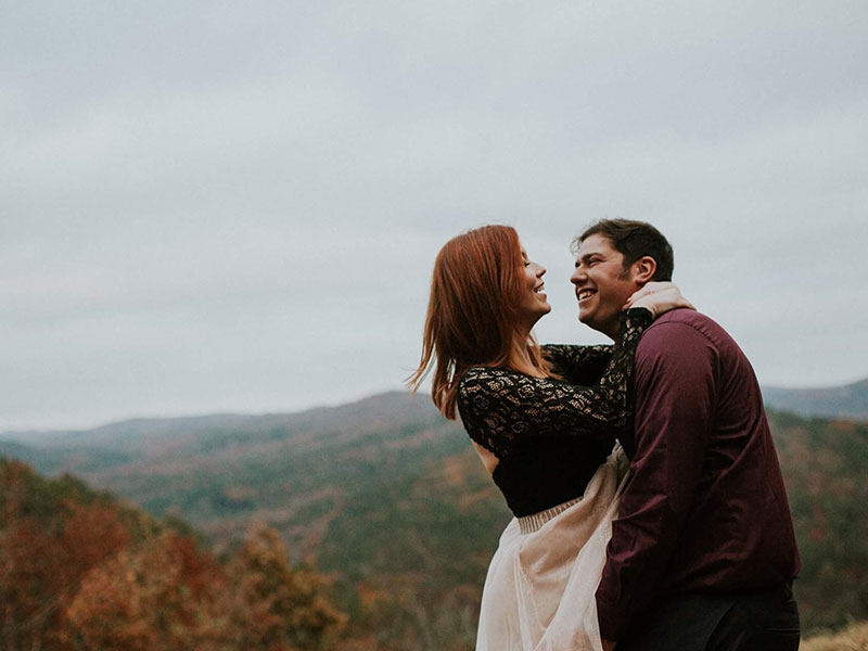 A woman who learned how to tell him you love him, hugging her boyfriend and looking into his eyes before kissing him.