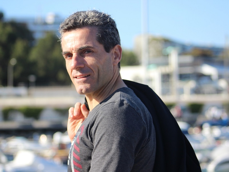 An attractive 50 year old man holding a jacket