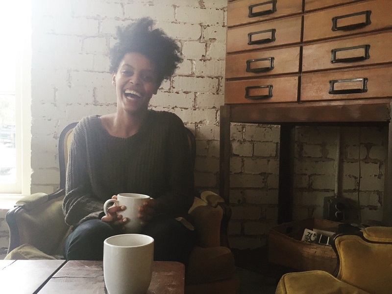 attractive woman laughing in cafe discussing am I ready to be in a relationship