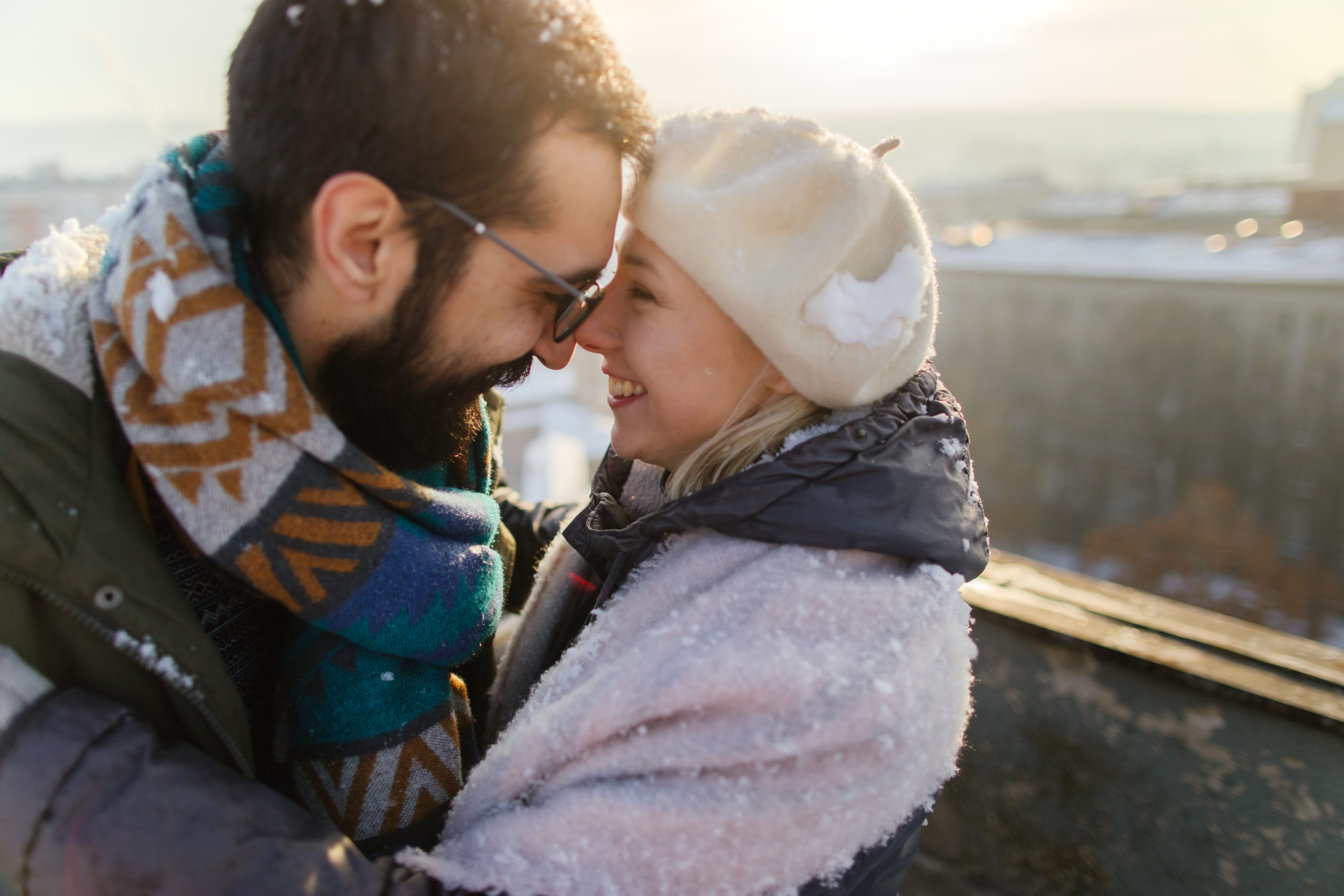Loving couple enjoying a snowy winter day while dating in New Jersey.