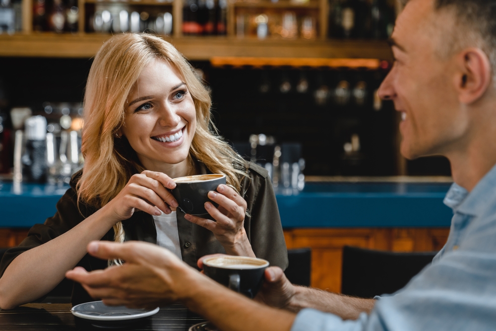 People having a conversation while on a coffee date.